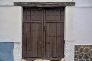 Vintage wooden door with rustic charm in Almagro, Spain. Perfect for architecture lovers.